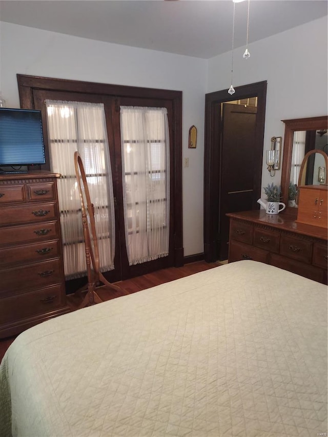 bedroom featuring dark wood-type flooring and french doors