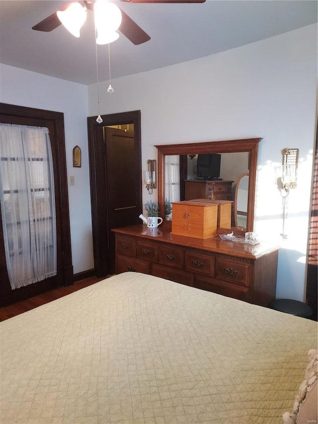 bedroom with dark wood-type flooring and ceiling fan