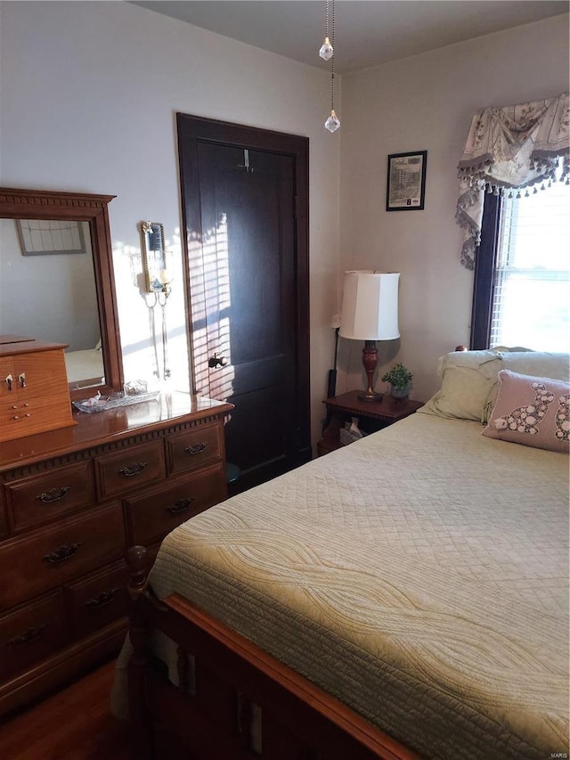 bedroom with hardwood / wood-style floors