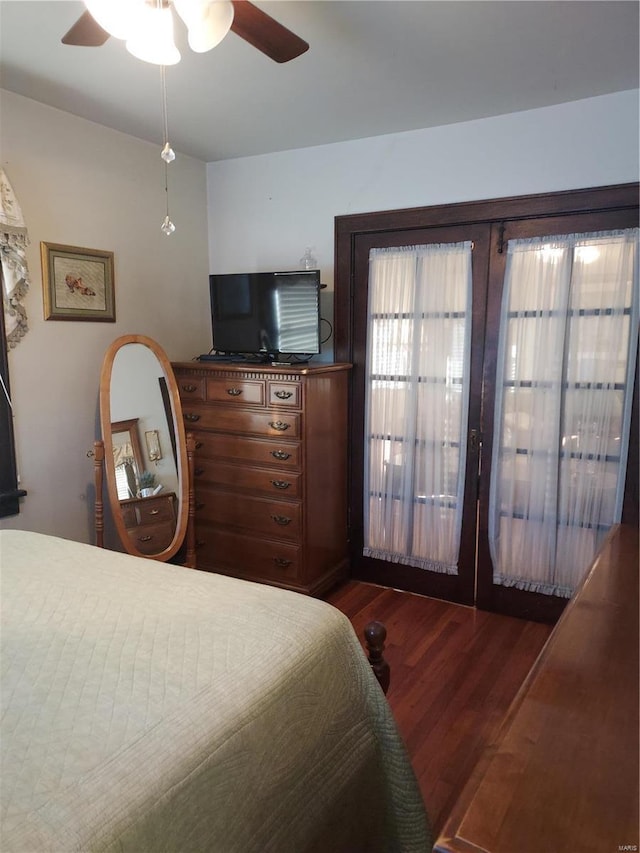 bedroom featuring dark wood-type flooring, ceiling fan, and french doors