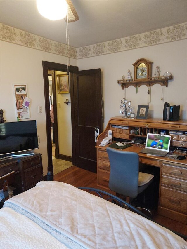 bedroom with dark hardwood / wood-style floors and ceiling fan