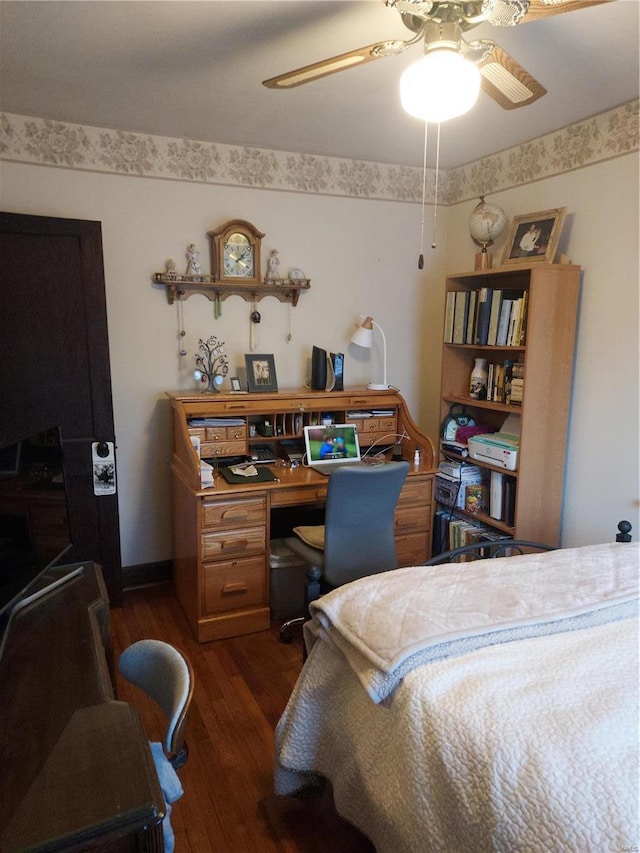 bedroom with dark hardwood / wood-style floors and ceiling fan