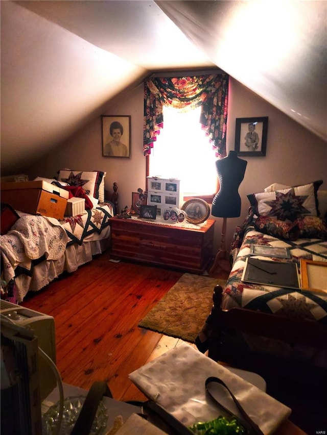 bedroom featuring lofted ceiling and hardwood / wood-style floors