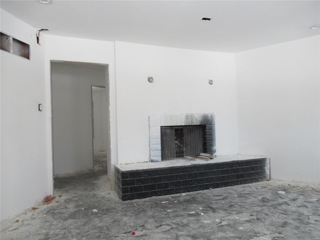 unfurnished living room with a brick fireplace