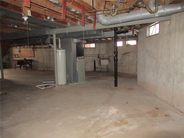 basement with sink, heating unit, and gas water heater