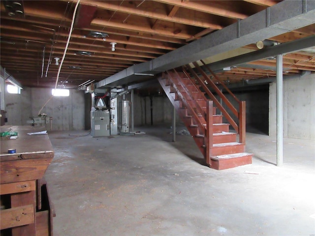 basement featuring gas water heater and heating unit