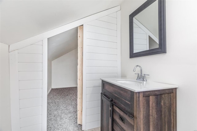 bathroom with lofted ceiling and vanity