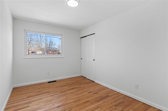 spare room with light hardwood / wood-style floors