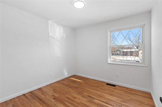 spare room featuring light hardwood / wood-style floors