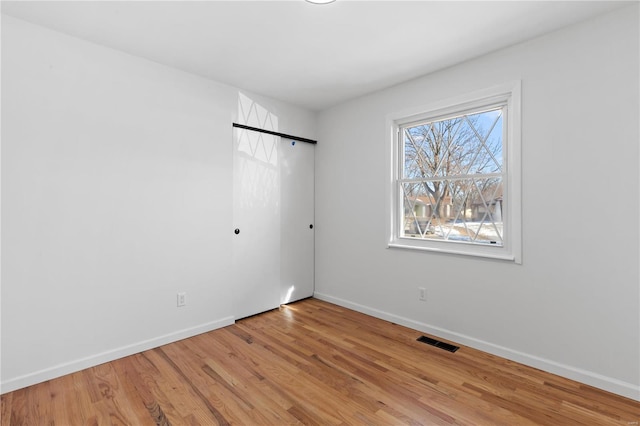 spare room featuring light wood-type flooring