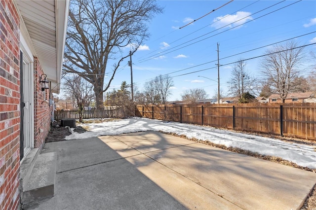 snow covered patio featuring central AC