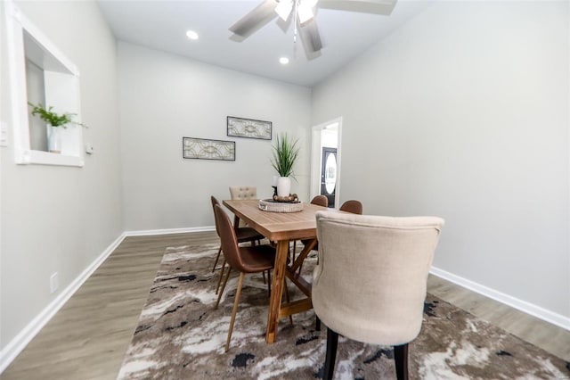 dining area with ceiling fan and wood-type flooring