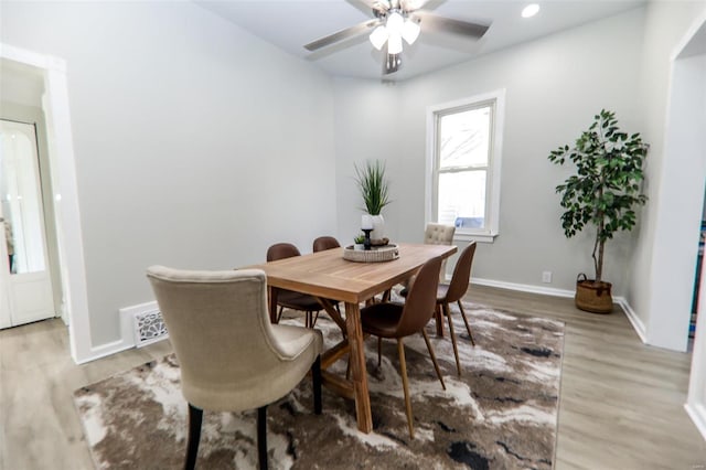 dining area with hardwood / wood-style flooring and ceiling fan