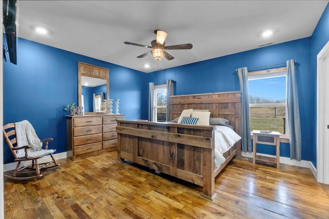 bedroom with ceiling fan and hardwood / wood-style floors