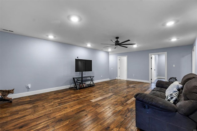 living room with dark wood-type flooring and ceiling fan