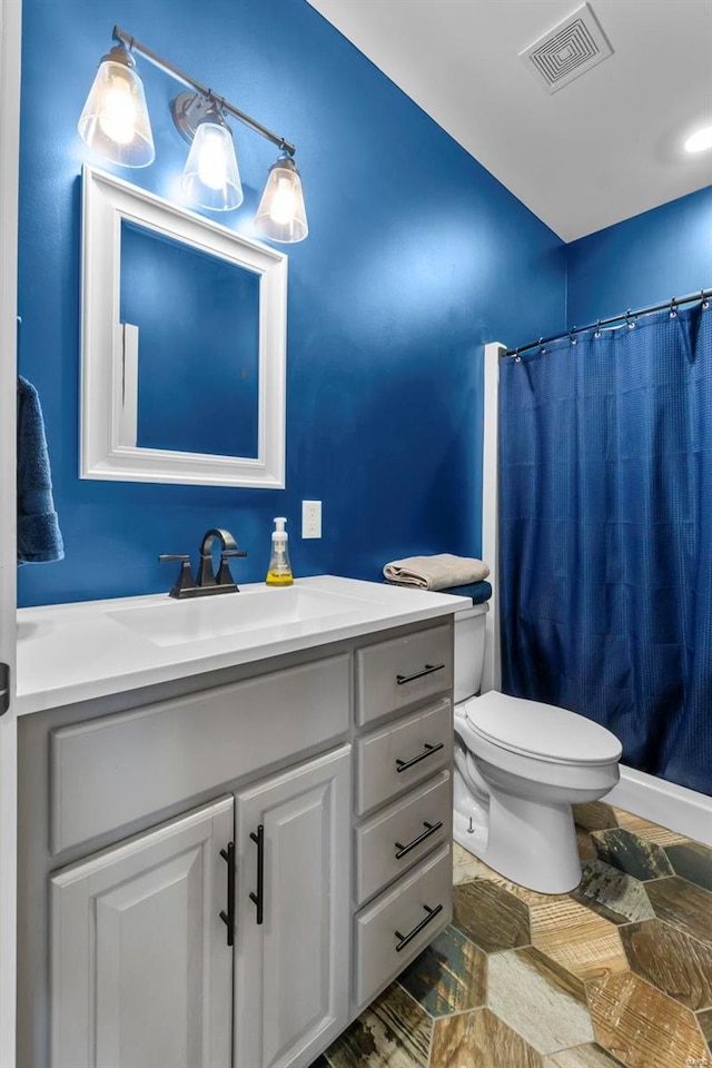 bathroom featuring vanity, a shower with curtain, and toilet