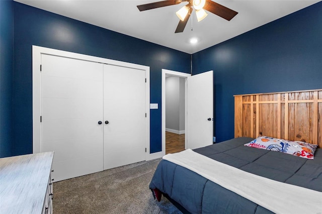 carpeted bedroom with ceiling fan and a closet