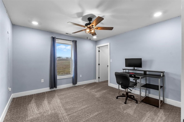 carpeted office space featuring ceiling fan