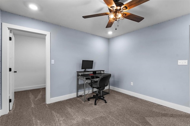 office space featuring dark colored carpet and ceiling fan