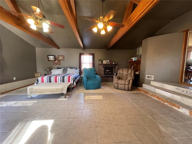 bedroom featuring a fireplace, light tile patterned flooring, lofted ceiling with beams, and ceiling fan