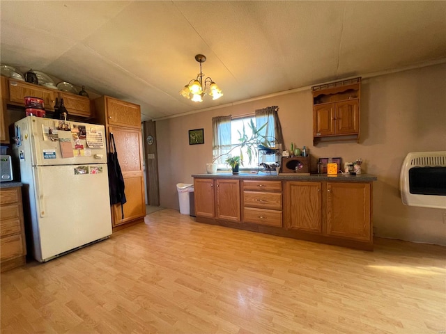 kitchen with a notable chandelier, white fridge, heating unit, decorative light fixtures, and vaulted ceiling