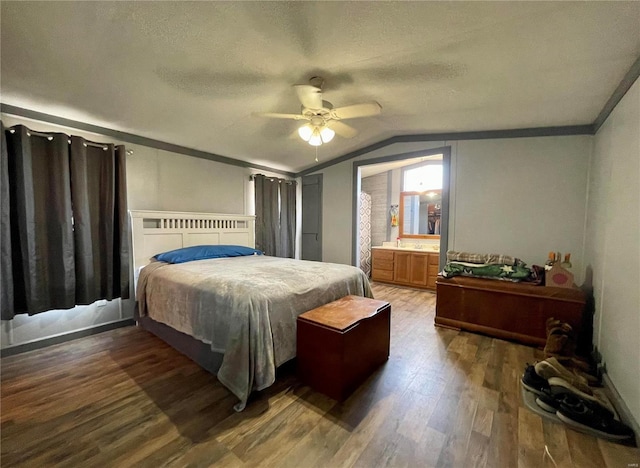 bedroom featuring a textured ceiling, hardwood / wood-style flooring, ceiling fan, connected bathroom, and lofted ceiling