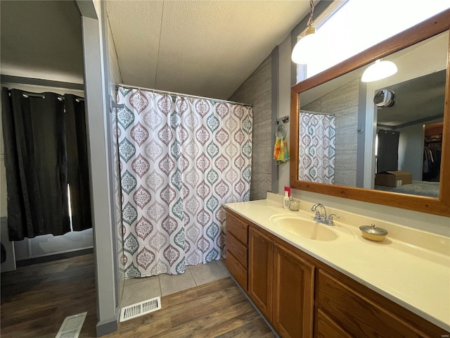 bathroom with vanity, hardwood / wood-style floors, and a textured ceiling