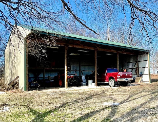 view of car parking with a pole building and a carport