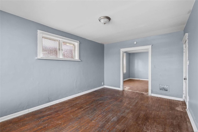 unfurnished room with dark wood-type flooring