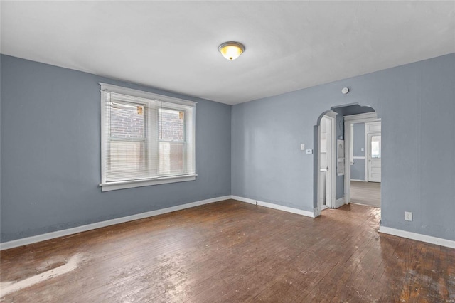 spare room with dark hardwood / wood-style flooring