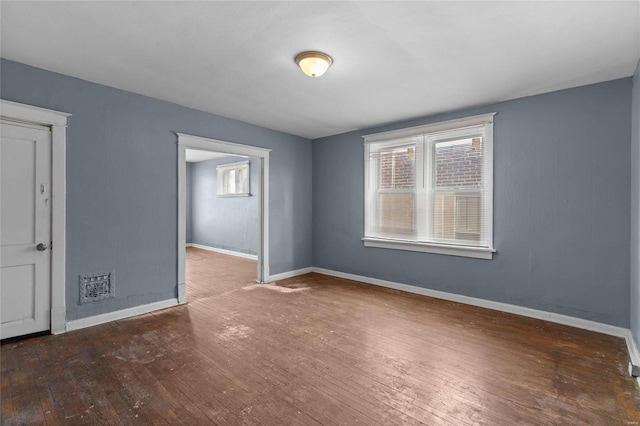 empty room with dark hardwood / wood-style flooring