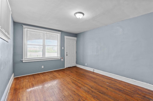 unfurnished room with wood-type flooring