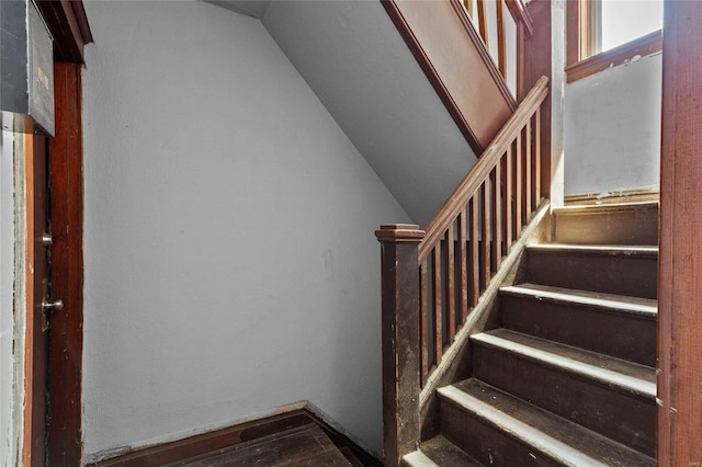 stairway with vaulted ceiling