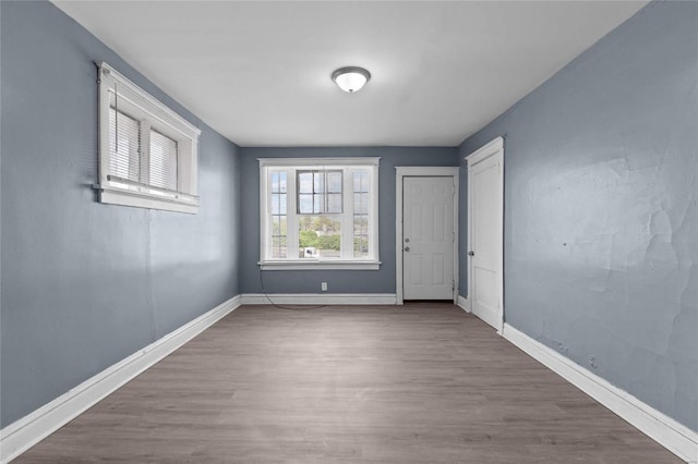 empty room with hardwood / wood-style flooring