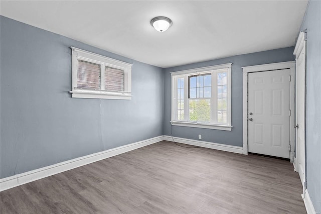 unfurnished room with wood-type flooring