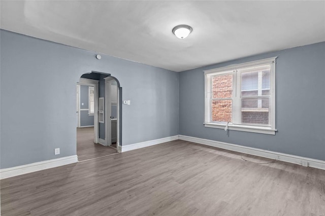 spare room featuring wood-type flooring