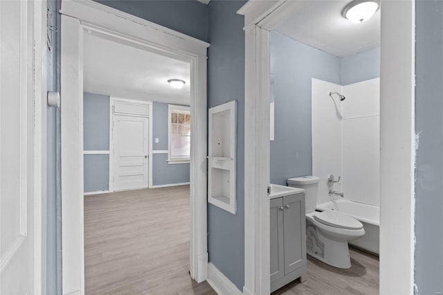 full bathroom featuring vanity, shower / bathing tub combination, hardwood / wood-style flooring, and toilet