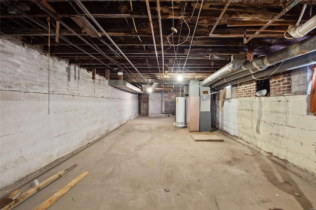 basement featuring heating unit and water heater