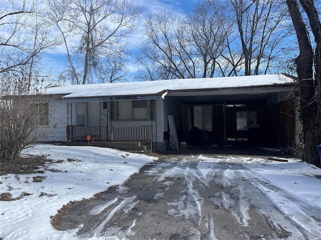 single story home featuring covered porch and a carport