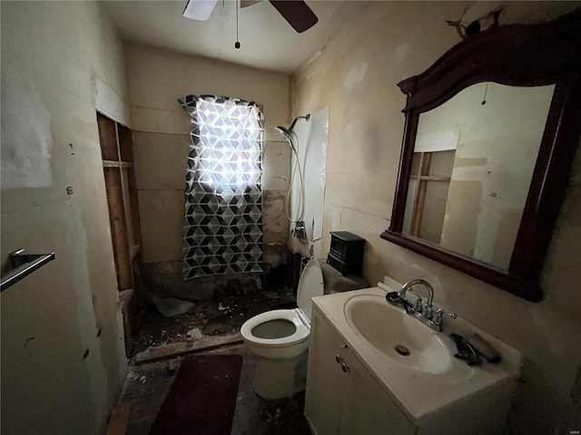 bathroom with a shower, toilet, vanity, and ceiling fan