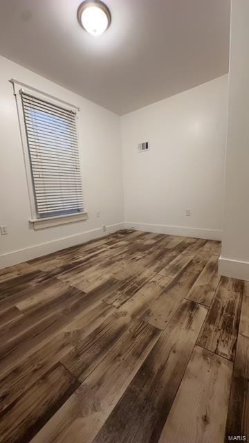 unfurnished room featuring dark hardwood / wood-style floors