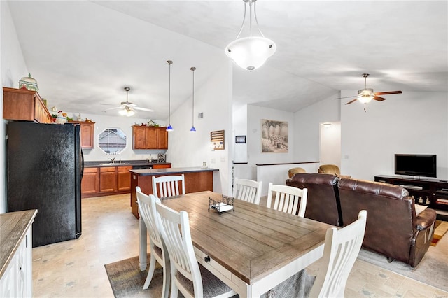 dining space featuring sink, ceiling fan, and lofted ceiling