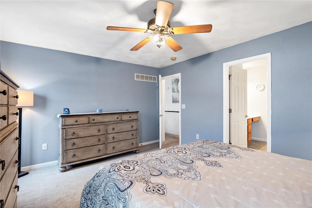 carpeted bedroom with ceiling fan and ensuite bath