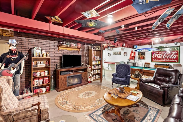 living room with billiards, brick wall, and a fireplace