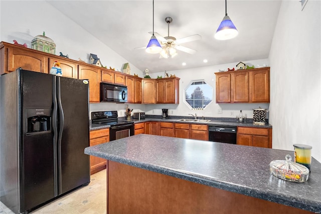 kitchen featuring dark countertops, lofted ceiling, hanging light fixtures, black appliances, and a sink