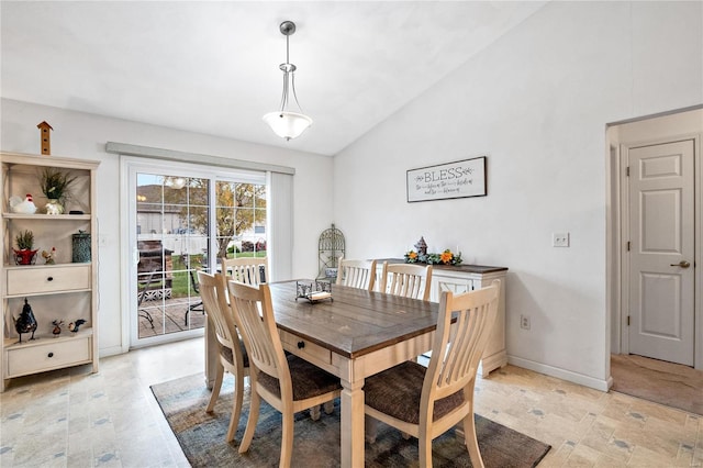 dining room with baseboards and lofted ceiling