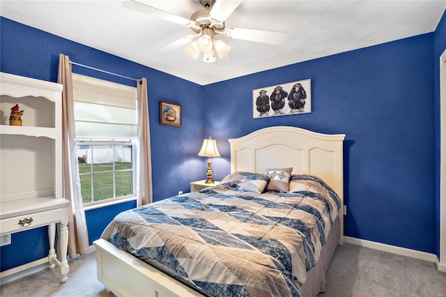 bedroom with ceiling fan, baseboards, and carpet floors