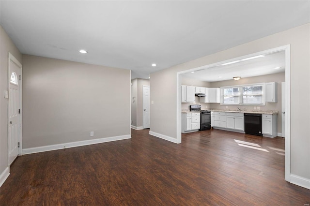 unfurnished living room featuring dark hardwood / wood-style floors