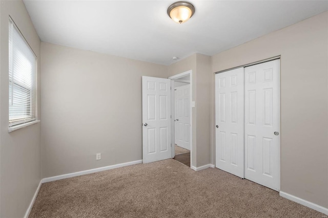 unfurnished bedroom with a closet and carpet