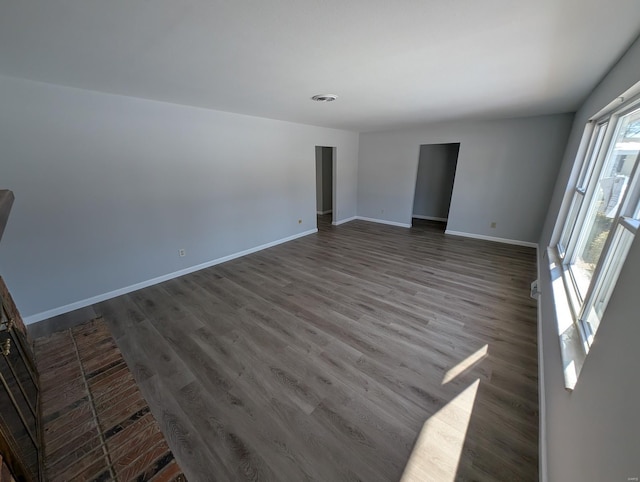 empty room with dark wood-type flooring